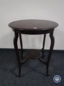 An Edwardian mahogany two tier occasional table