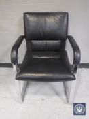A black vinyl Vitra office armchair