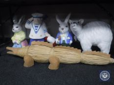 A wood and wicker figure of a crocodile together with five contemporary painted figures of rabbits,