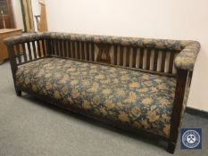 An Arts and Crafts oak framed settee, width 204 cm.