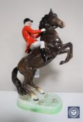 A Beswick figure of a huntsman on rearing horse,