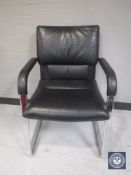 A black vinyl Vitra office armchair