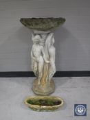 A concrete garden bird bath and small trough