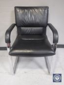 A black vinyl Vitra office armchair
