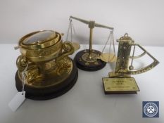 A reproduction brass ship's style compass on wooden stand together with a Franklin Mint brass