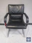 A black vinyl Vitra office armchair