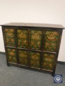 An Eastern polychrome painted four-door low cabinet,