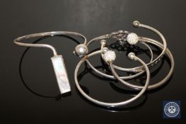 Four sterling silver and one white metal bangle (5)