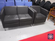 A grey vinyl two-piece reception suite on metal legs