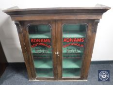 A Victorian glazed door bookcase top bearing advertising