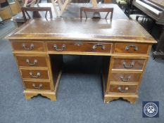 A yew wood twin pedestal writing desk
