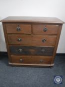A Victorian oak five drawer chest