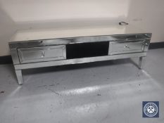 A mirrored entertainment stand fitted two drawers