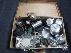 A vintage leather luggage case containing stainless steel and plated wares,