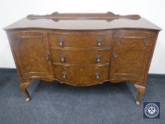 A burr walnut serpentine-fronted sideboard