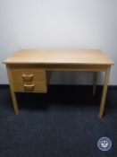 A beech desk fitted two drawers