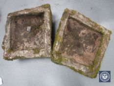 A pair of weathered stone garden planters