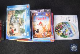 Approximately thirty-eight Disney and Ravensbrough jigsaws