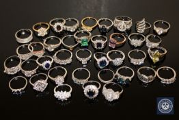 Thirty-eight silver dress rings, variously set with cubic zirconia, garnet, synthetic sapphires,