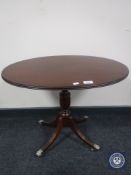 A Regency style mahogany oval topped wine table