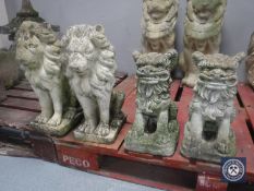 A pair of garden lion figures and a pair of foo dogs