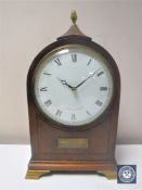 A 20th century inlaid mahogany mantel clock with lion mask handles by Comitti of London on brass