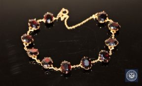 A 9ct gold garnet set bracelet CONDITION REPORT: 11.