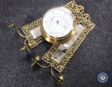 A pair of brass framed narrow wall mirrors with candle sconces together with a ship's style aneroid