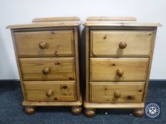 A pair of pine three drawer bedside chests