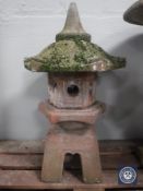 A concrete garden pagoda lantern and two wall pockets