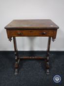A Regency rosewood work table on paw feet