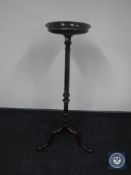 A mahogany twist stem torchere on tripod base