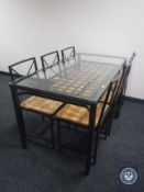 A metal glass topped dining table and six rush seated chairs