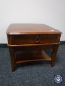 A reproduction lamp table fitted a drawer