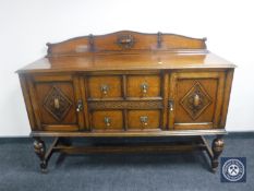 An oak sideboard CONDITION REPORT: 101cm high, 150cm wide, 50cm deep.