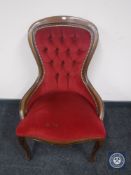 A reproduction lady's chair in red button dralon