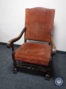 A continental carved oak scroll arm armchair