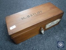 A mahogany box with key bearing the name 