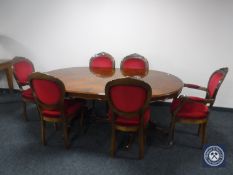 An oval Italianate pedestal dining table together with six chairs comprising two carvers and four