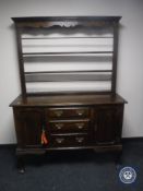 A George III style oak dresser with plate rack (one leg detached)