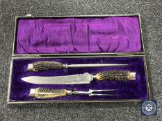 A boxed carving set with silver ferrules by Henry Elliott 7 sons,