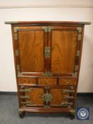 An Oriental elm double door cabinet, width 90 cm.