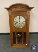An early 20th century oak Lenzkirch wall clock with silvered dial and Westminster chime,