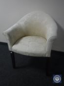 A 20th century armchair in cream floral fabric