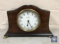 A mahogany cased eight day mantel clock raised on brass feet,