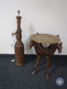 A carved hardwood table lamp with a brass topped occasional table