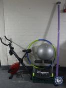 A folding exercise bike together with assorted fitness equipment, dumbbells,