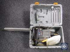 A cased Ryobi chain saw