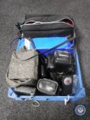 A crate of assorted vintage cameras and a cine camera