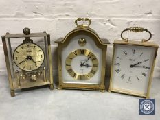 Three brass cased battery operated clocks by Kundo,